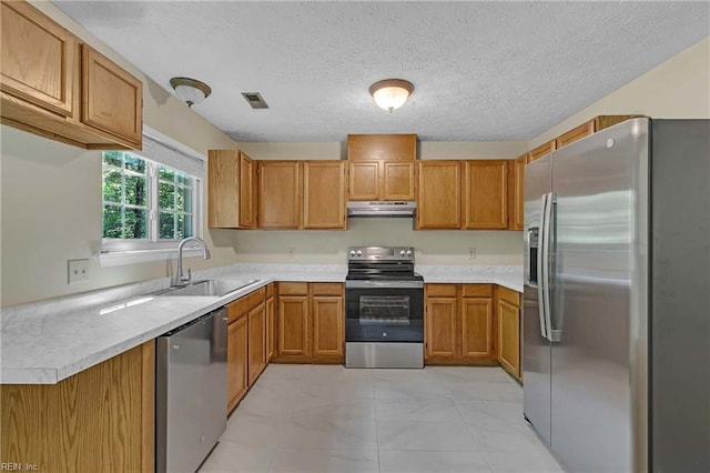 4505 Wimbledon Way, Williamsburg, VA 23188 - kitchen with stainless steel appliances, under cabinet range hood, light countertops, brown cabinets, and a textured ceiling