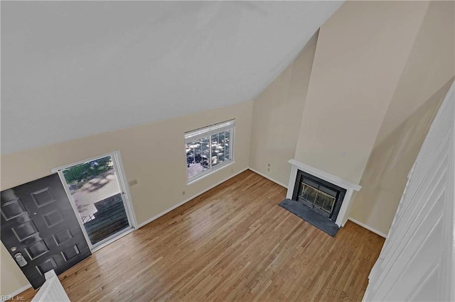 4505 Wimbledon Way, Williamsburg, VA 23188 - unfurnished living room featuring wood finished floors, a fireplace with raised hearth, and vaulted ceiling