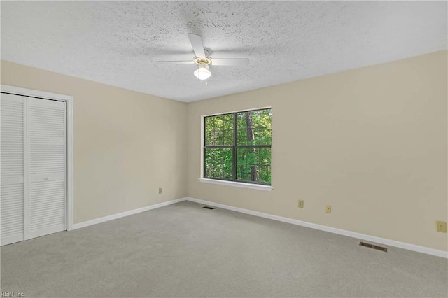 4505 Wimbledon Way, Williamsburg, VA 23188 - unfurnished bedroom with carpet flooring, a closet, a textured ceiling, and ceiling fan