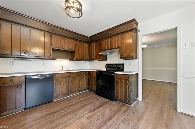 60 Dillwyn Dr, Newport News, VA 23602 - kitchen featuring black appliances, under cabinet range hood, wood finished floors, light countertops, and crown molding