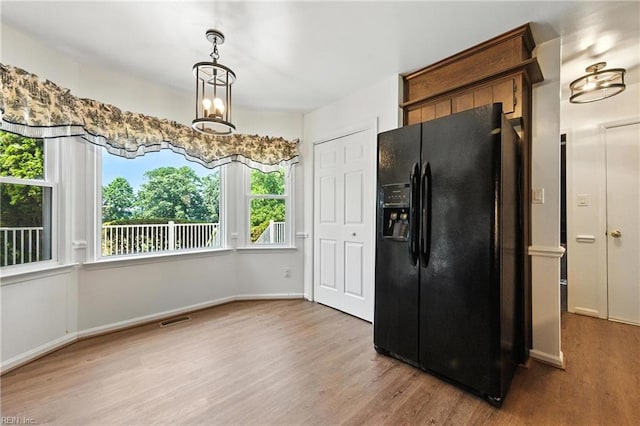 60 Dillwyn Dr, Newport News, VA 23602 - kitchen with black fridge, light wood-style flooring, and a chandelier