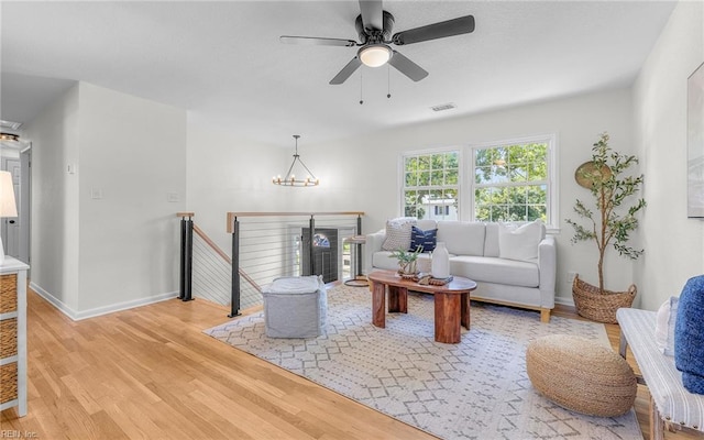 3048 John Hancock Dr, Virginia Beach, VA 23452 - living area featuring light wood-style flooring, a ceiling fan, and a chandelier