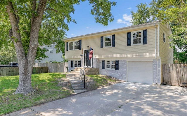 3048 John Hancock Dr, Virginia Beach, VA 23452 - bi-level home featuring brick siding, driveway, and a garage