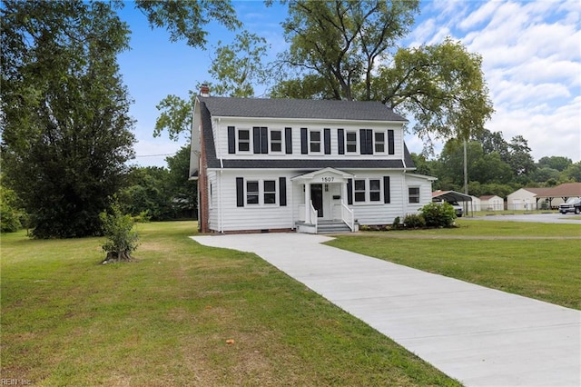 1507 Todds Ln, Hampton, VA 23666 - dutch colonial featuring a chimney, driveway, a front lawn, and a detached carport