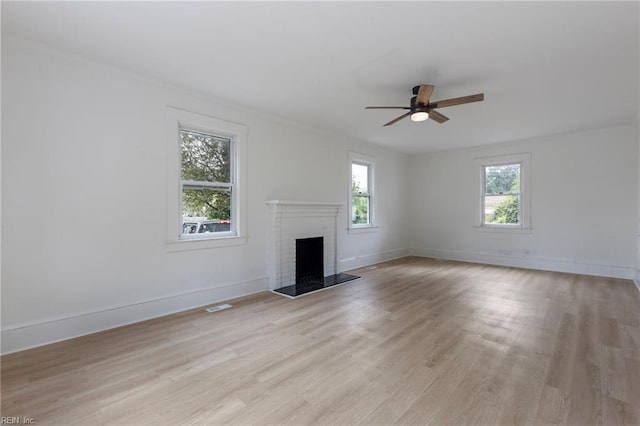 1507 Todds Ln, Hampton, VA 23666 - unfurnished living room with light wood-style floors, ceiling fan, and a fireplace