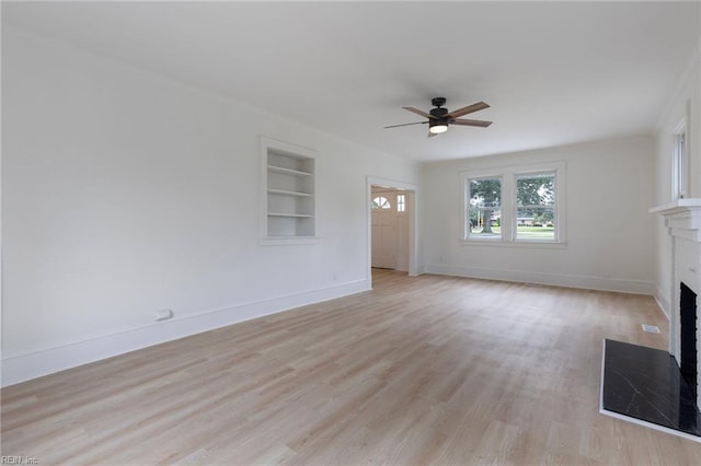 1507 Todds Ln, Hampton, VA 23666 - unfurnished living room featuring a fireplace with flush hearth, built in features, ceiling fan, and light wood-style floors