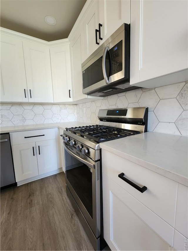 110 S Willard Ave, Hampton, VA 23663 - kitchen featuring stainless steel appliances, light countertops, dark wood finished floors, and white cabinets