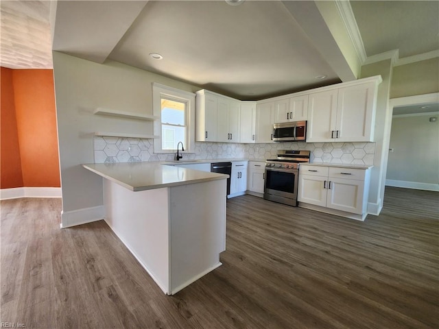 110 S Willard Ave, Hampton, VA 23663 - kitchen with appliances with stainless steel finishes, a peninsula, ornamental molding, white cabinetry, and recessed lighting