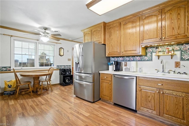 236 Haledon Rd, Chesapeake, VA 23320 - kitchen featuring appliances with stainless steel finishes, brown cabinetry, light wood-style floors, light countertops, and a ceiling fan