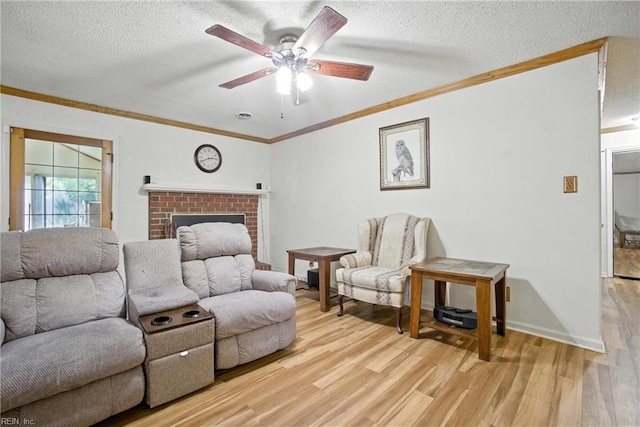 236 Haledon Rd, Chesapeake, VA 23320 - living area with light wood-style floors, ceiling fan, crown molding, a textured ceiling, and a brick fireplace