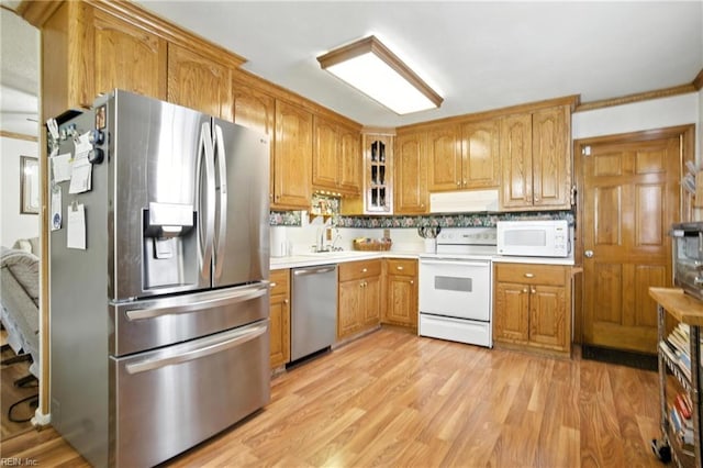 236 Haledon Rd, Chesapeake, VA 23320 - kitchen with appliances with stainless steel finishes, ventilation hood, glass insert cabinets, light countertops, and light wood-type flooring