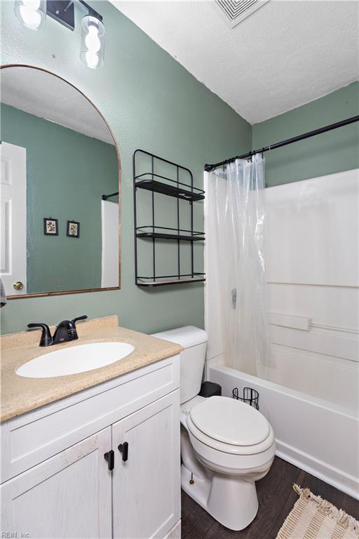 3009 Aaron Dr, Chesapeake, VA 23323 - bathroom with vanity, wood finished floors, and shower / tub combo with curtain