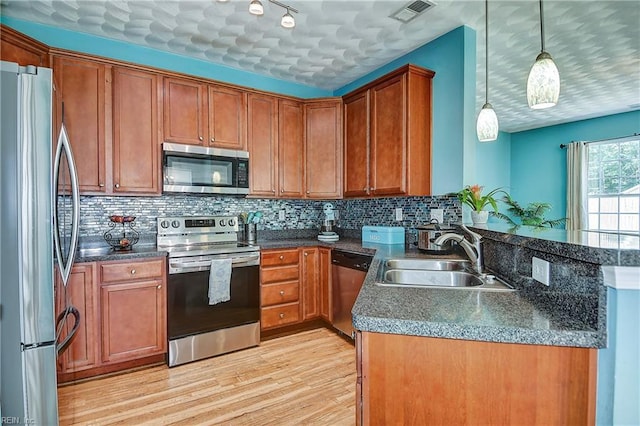 1212 Gunn Hall Dr, Virginia Beach, VA 23454 - kitchen featuring appliances with stainless steel finishes, brown cabinets, light wood finished floors, and dark countertops