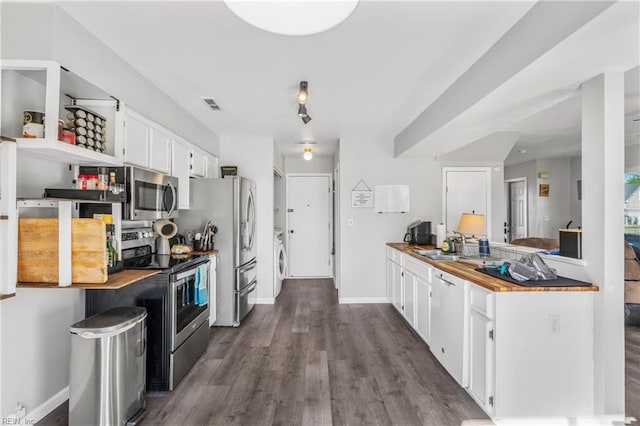1536 Eagleton Ln, Virginia Beach, VA 23455 - kitchen with appliances with stainless steel finishes, white cabinetry, dark wood finished floors, washer / dryer, and wood counters