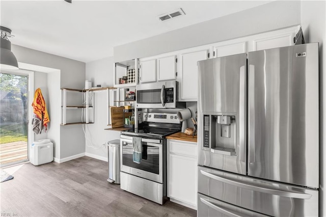 1536 Eagleton Ln, Virginia Beach, VA 23455 - kitchen featuring appliances with stainless steel finishes, white cabinetry, dark wood finished floors, light countertops, and open shelves