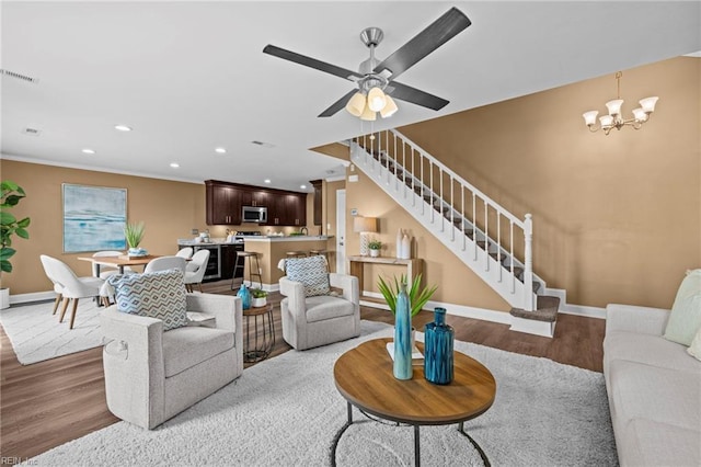5001 Heathglen Cir, Virginia Beach, VA 23456 - living room featuring light wood finished floors, stairs, recessed lighting, crown molding, and a chandelier