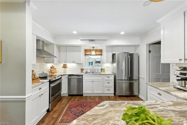 4704 Haygood Point Rd, Virginia Beach, VA 23455 - kitchen featuring stainless steel appliances, wall chimney range hood, ornamental molding, dark wood-style floors, and backsplash