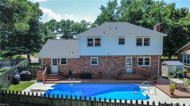 4704 Haygood Point Rd, Virginia Beach, VA 23455 - back of property with a fenced backyard, brick siding, a chimney, a shed, and a patio area