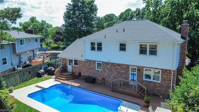 4704 Haygood Point Rd, Virginia Beach, VA 23455 - rear view of property featuring a deck, a fenced backyard, brick siding, and a chimney