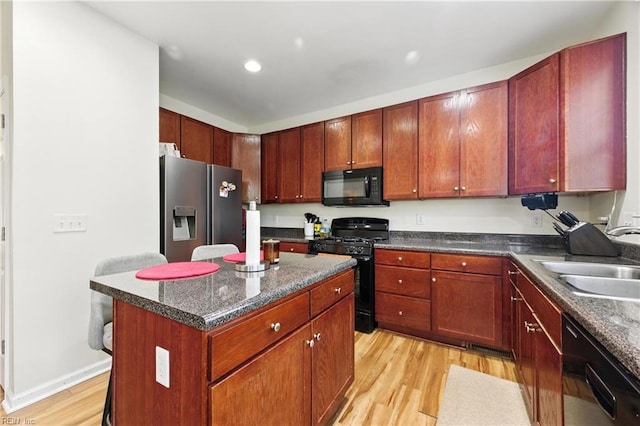 622 Jessica Cir Unit 21, Newport News, VA 23606 - kitchen featuring black appliances, light wood-style floors, a center island, recessed lighting, and dark stone countertops