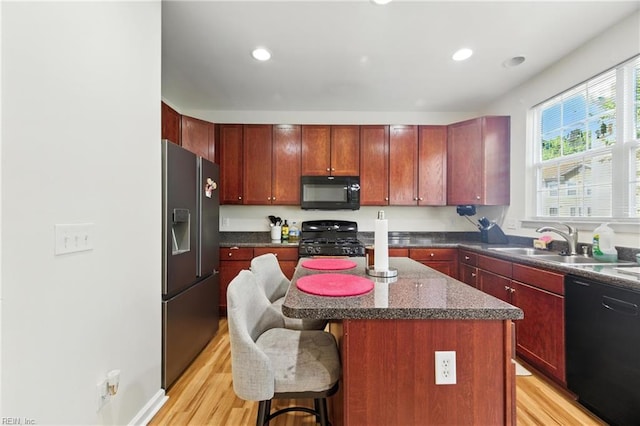622 Jessica Cir Unit 21, Newport News, VA 23606 - kitchen with black appliances, dark brown cabinets, light wood-type flooring, dark countertops, and recessed lighting