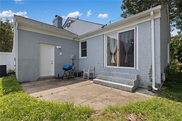 503 Carters Grove Ct, Hampton, VA 23663 - back of house featuring brick siding, a patio, and a chimney