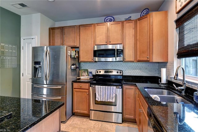 3472 Westham Ln, Toano, VA 23168 - kitchen with appliances with stainless steel finishes, tasteful backsplash, dark stone countertops, and brown cabinets