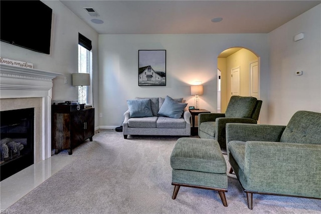 3472 Westham Ln, Toano, VA 23168 - living area featuring a glass covered fireplace, arched walkways, and carpet