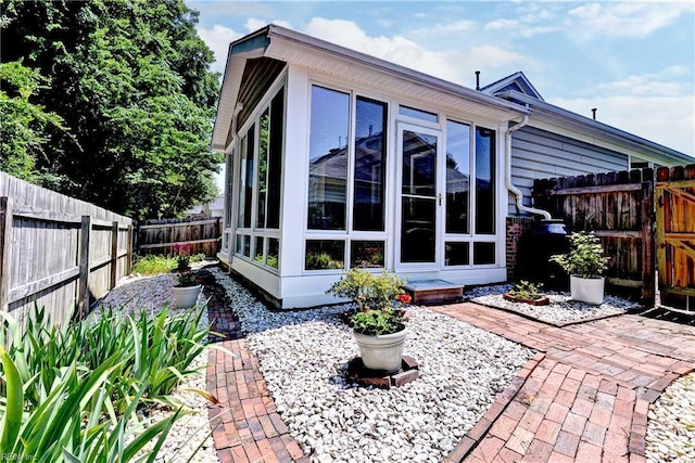 601 Commons Way, Williamsburg, VA 23185 - rear view of house featuring a sunroom, a fenced backyard, and a patio area