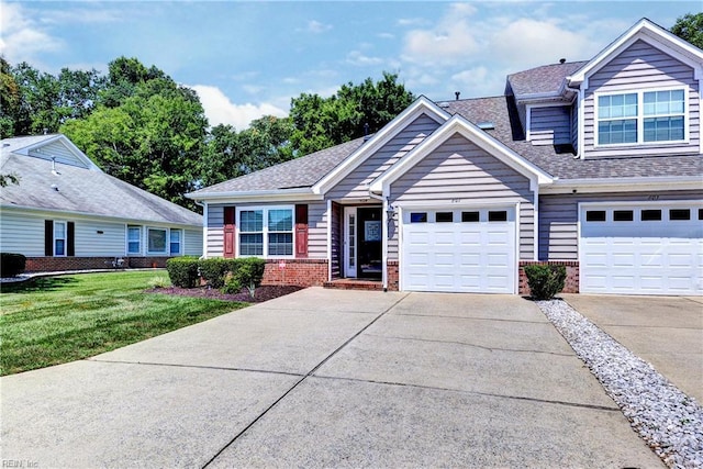 601 Commons Way, Williamsburg, VA 23185 - view of front of home featuring brick siding, a front lawn, concrete driveway, and roof with shingles