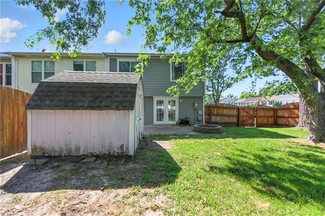 3725 Kingsmill Walk, Virginia Beach, VA 23452 - rear view of property with french doors, a storage unit, a fenced backyard, roof with shingles, and an outdoor fire pit