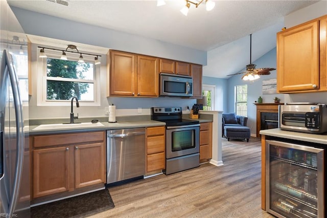 1504 River Creek Cres, Suffolk, VA 23434 - kitchen featuring appliances with stainless steel finishes, wine cooler, light wood finished floors, vaulted ceiling, and ceiling fan
