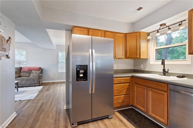 1504 River Creek Cres, Suffolk, VA 23434 - kitchen with stainless steel appliances, light wood finished floors, open floor plan, light countertops, and a textured ceiling