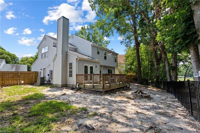 1504 River Creek Cres, Suffolk, VA 23434 - back of house with a wooden deck, a fenced backyard, a chimney, and a fire pit