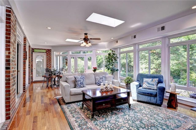 2093 Harpers Ml, Williamsburg, VA 23185 - living room featuring a skylight, a ceiling fan, light wood-type flooring, and plenty of natural light