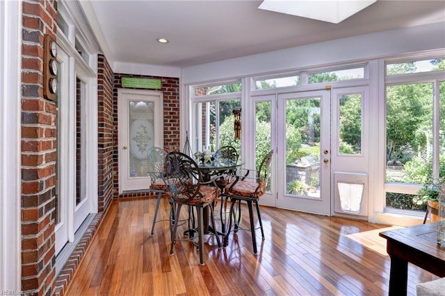 2093 Harpers Ml, Williamsburg, VA 23185 - sunroom with hardwood / wood-style floors, a skylight, a wooden deck, brick wall, and french doors