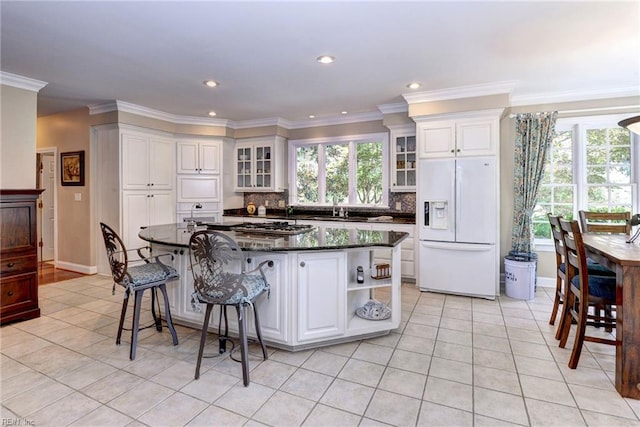 2093 Harpers Ml, Williamsburg, VA 23185 - kitchen featuring white fridge with ice dispenser, light tile patterned floors, plenty of natural light, recessed lighting, and crown molding