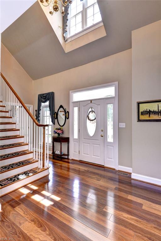 2093 Harpers Ml, Williamsburg, VA 23185 - foyer with a chandelier, a high ceiling, wood finished floors, and stairway