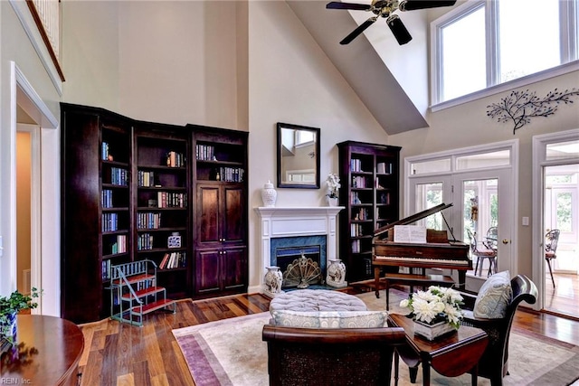 2093 Harpers Ml, Williamsburg, VA 23185 - living room featuring high vaulted ceiling, a fireplace, a ceiling fan, and wood finished floors