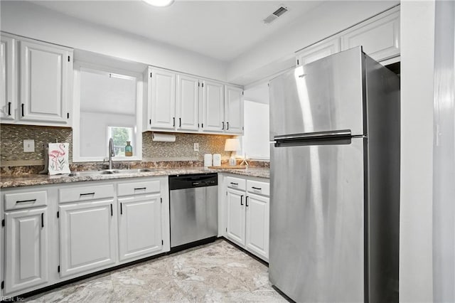 4136 Stonebridge Lndg, Chesapeake, VA 23321 - kitchen with appliances with stainless steel finishes, white cabinetry, decorative backsplash, and light stone counters