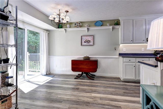 3284 Reades Way, Williamsburg, VA 23185 - kitchen featuring dark countertops, wainscoting, a chandelier, wood finished floors, and open shelves