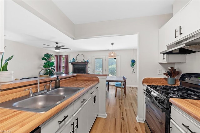 701 Hecate Dr, Virginia Beach, VA 23454 - kitchen featuring black range with gas stovetop, under cabinet range hood, light wood finished floors, white cabinets, and a ceiling fan