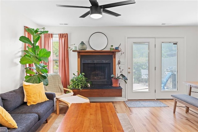 701 Hecate Dr, Virginia Beach, VA 23454 - living room featuring wood finished floors, a fireplace with raised hearth, and a ceiling fan