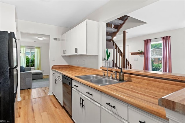 701 Hecate Dr, Virginia Beach, VA 23454 - kitchen with black appliances, light wood-style floors, light countertops, and white cabinetry
