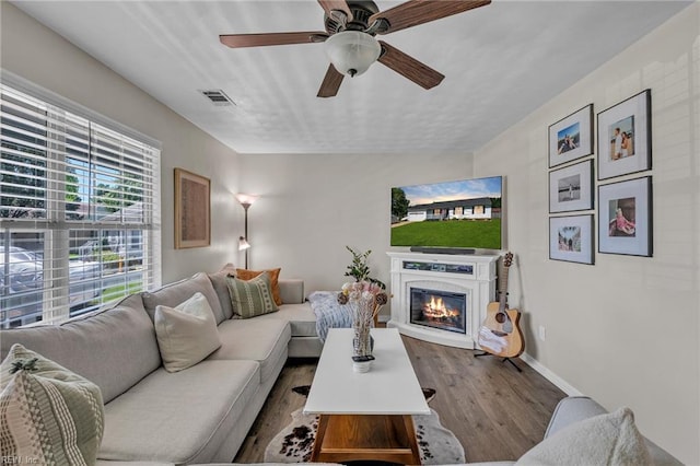 3414 Winterhawk Ct, Chesapeake, VA 23323 - living room featuring dark wood-type flooring, a glass covered fireplace, and a ceiling fan