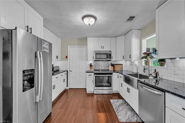 3414 Winterhawk Ct, Chesapeake, VA 23323 - kitchen featuring stainless steel appliances, decorative backsplash, dark wood-type flooring, and white cabinetry
