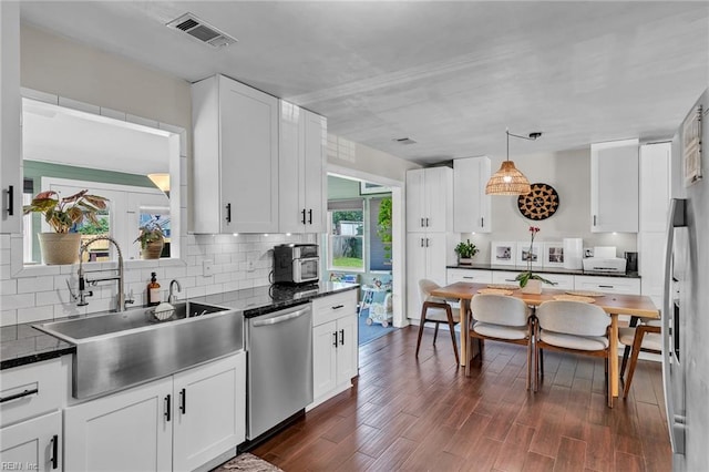 3414 Winterhawk Ct, Chesapeake, VA 23323 - kitchen with stainless steel dishwasher, decorative backsplash, white cabinetry, and dark wood finished floors