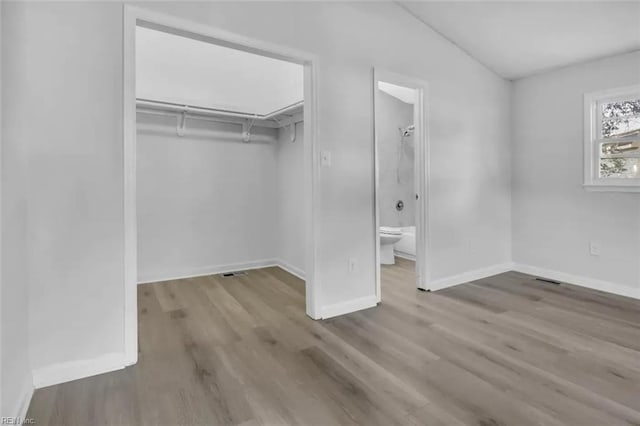 11 Alpine St, Newport News, VA 23606 - unfurnished bedroom with wood finished floors, a closet, and ensuite bathroom