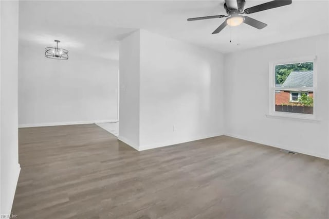 11 Alpine St, Newport News, VA 23606 - empty room with wood finished floors, a ceiling fan, and a chandelier
