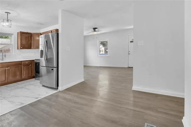 11 Alpine St, Newport News, VA 23606 - kitchen with stainless steel fridge, plenty of natural light, a ceiling fan, and brown cabinets